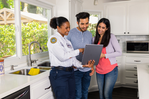 electrician discussing joules and whole home surge protection with homeowners