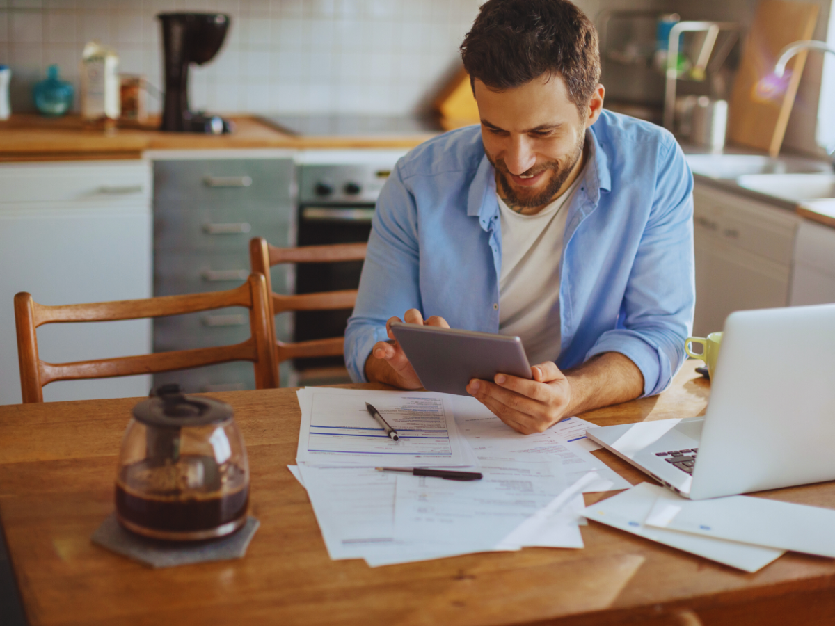 Happy homeowner realizing how much ceiling fans saves on energy bills
