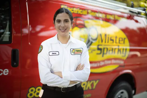 Mister Sparky Electrician Tech, Jane, outsider her van in front of a Daytona Beach home.