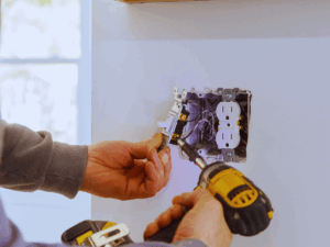 electrician fixing outlet with open ground