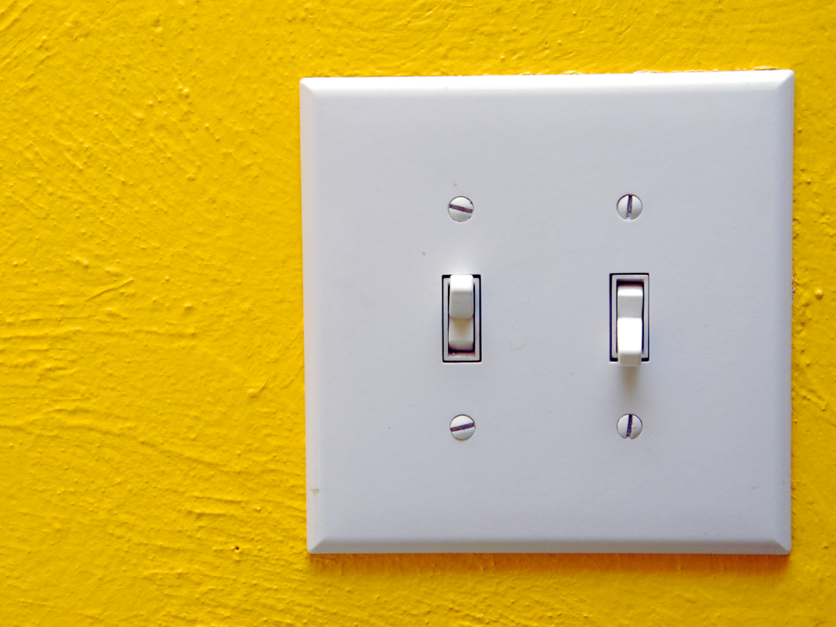 Light switch on yellow wall